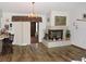 Cozy living room with a fireplace and hardwood floors at 7591 Limonia Dr, Indian Lake Estates, FL 33855