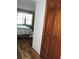 View of the main bedroom featuring wooden floors, and a green accent wall at 7591 Limonia Dr, Indian Lake Estates, FL 33855