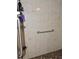 Walk-in shower area with handrails, tiled walls and built in shelves at 7591 Limonia Dr, Indian Lake Estates, FL 33855