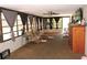 Bright sun room surrounded by natural light featuring comfortable seating and wood flooring at 7591 Limonia Dr, Indian Lake Estates, FL 33855