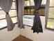 A window with drapes and an air conditioning unit at 7591 Limonia Dr, Indian Lake Estates, FL 33855