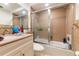 Tiled bathroom featuring a tub, shower, vanity, and updated fixtures at 821 Orchid Springs Dr # 821, Winter Haven, FL 33884