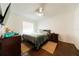 Cozy bedroom featuring hardwood floors, a ceiling fan, and a comfortable queen-sized bed at 821 Orchid Springs Dr # 821, Winter Haven, FL 33884