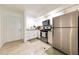 Well-lit kitchen with stainless steel appliances, white cabinetry, and tiled flooring at 821 Orchid Springs Dr # 821, Winter Haven, FL 33884