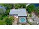 Aerial view of house with screened pool and patio surrounded by mature landscaping at 882 Redwood Way, Lake Wales, FL 33898