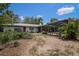 A view of the backyard featuring a partially screened pool area and lush landscaping to enhance privacy at 882 Redwood Way, Lake Wales, FL 33898
