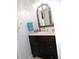 Bathroom vanity with decorative mirror, white marble countertop, dark cabinets and stylish fixtures at 882 Redwood Way, Lake Wales, FL 33898