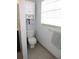 Bathroom features a toilet, towel rack and light blue walls at 882 Redwood Way, Lake Wales, FL 33898