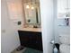 Bathroom features a double vanity, nice mirror, dark cabinets and great lighting at 882 Redwood Way, Lake Wales, FL 33898