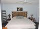 Bedroom features a rustic wood headboard, dark wood floors and modern accents at 882 Redwood Way, Lake Wales, FL 33898