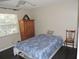 Bedroom featuring wooden furniture, a comfortable bed, a window and hardwood flooring at 882 Redwood Way, Lake Wales, FL 33898