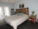 Bedroom features a rustic wood headboard, dark wood floors and modern accents at 882 Redwood Way, Lake Wales, FL 33898