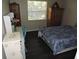 Bedroom with natural light, wooden furnishings, hardwood floors, and a comfortable bed at 882 Redwood Way, Lake Wales, FL 33898