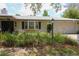 Close up of home featuring lush landscaping, and a large two-car garage at 882 Redwood Way, Lake Wales, FL 33898