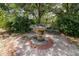 Stone fountain with surrounding greenery creating a serene garden landscape at 882 Redwood Way, Lake Wales, FL 33898