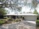 Charming home featuring mature landscaping, an attached garage, and a well-maintained front yard at 882 Redwood Way, Lake Wales, FL 33898
