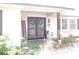 Charming front porch area with a welcoming welcome sign and an inviting double-door entrance at 882 Redwood Way, Lake Wales, FL 33898