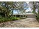 Charming single-story home featuring a spacious driveway, two-car garage, and well-manicured landscaping at 882 Redwood Way, Lake Wales, FL 33898