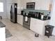 Well-lit kitchen with stainless steel appliances, tile flooring, and ample counter space for cooking and entertaining at 882 Redwood Way, Lake Wales, FL 33898