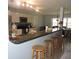 Kitchen with a breakfast bar, ample counter space, and views into the dining area at 882 Redwood Way, Lake Wales, FL 33898