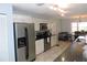 Bright kitchen features stainless steel appliances and white cabinetry, seamlessly connected to the dining area at 882 Redwood Way, Lake Wales, FL 33898