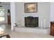 Living room showcasing fireplace, neutral paint, tile flooring, and a view into the entryway at 882 Redwood Way, Lake Wales, FL 33898