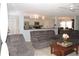 Inviting living room with plush seating, open to the kitchen and dining area creating a spacious feel at 882 Redwood Way, Lake Wales, FL 33898