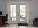 Bright room with a white patio door leading to a screened-in pool and covered patio area at 882 Redwood Way, Lake Wales, FL 33898