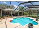 Enjoy the refreshing screened-in pool area, complete with a pool, patio, and lush landscaping for a private escape at 882 Redwood Way, Lake Wales, FL 33898