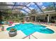 Inviting screened-in pool area with a sparkling pool, patio and comfortable lounge chairs for relaxing by the water at 882 Redwood Way, Lake Wales, FL 33898