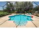 Inviting pool area with a sparkling blue pool, deck chairs, and a serene screened enclosure at 882 Redwood Way, Lake Wales, FL 33898