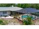 Aerial view of a sparkling blue swimming pool with screened-in enclosure at 882 Redwood Way, Lake Wales, FL 33898