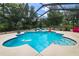 Sparkling blue pool with a serene screened enclosure, perfect for outdoor relaxation at 882 Redwood Way, Lake Wales, FL 33898