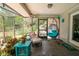 Relaxing screened porch with comfortable seating, plants, and an outdoor view at 882 Redwood Way, Lake Wales, FL 33898