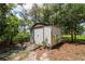 Utility shed surrounded by lush landscaping and trees at 882 Redwood Way, Lake Wales, FL 33898