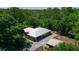 An aerial view of a home with a metal roof, surrounded by mature trees at 9365 Lemon Dr, Lake Wales, FL 33898