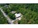 An aerial view showing a home with a white roof surrounded by trees and green landscape at 9365 Lemon Dr, Lake Wales, FL 33898