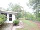 Exterior view of a home with a backyard, showing a garden and exterior access at 9365 Lemon Dr, Lake Wales, FL 33898