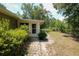 Quaint backyard with a stone pathway leading to a charming back door and lush greenery at 9365 Lemon Dr, Lake Wales, FL 33898
