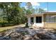 Backyard with mature trees, sandy ground, and a view of a shed beyond the back of the house at 9365 Lemon Dr, Lake Wales, FL 33898