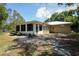 View of the home's backyard featuring a screened-in porch and a partially fenced in yard at 9365 Lemon Dr, Lake Wales, FL 33898