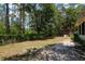 Spacious backyard with mature trees and a shed with a chain link fence at 9365 Lemon Dr, Lake Wales, FL 33898