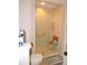 Glass shower with seat in bright bathroom at 9365 Lemon Dr, Lake Wales, FL 33898