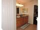 Bright bathroom featuring a double vanity with wood cabinets and tile flooring at 9365 Lemon Dr, Lake Wales, FL 33898