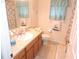 Inviting bathroom featuring a granite vanity, soft lighting, and tile flooring at 9365 Lemon Dr, Lake Wales, FL 33898