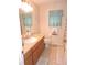 Inviting bathroom featuring a granite vanity, soft lighting, and tile flooring at 9365 Lemon Dr, Lake Wales, FL 33898
