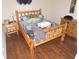 Cozy bedroom featuring a rustic wooden bed frame and hardwood floors at 9365 Lemon Dr, Lake Wales, FL 33898