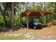 Covered carport with vehicles and equipment, offering shaded parking at 9365 Lemon Dr, Lake Wales, FL 33898