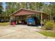 Metal carport with vehicles and chairs, providing covered parking at 9365 Lemon Dr, Lake Wales, FL 33898