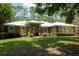 Inviting single-story home with a well-manicured lawn, American flag and attractive stone accents enhance curb appeal at 9365 Lemon Dr, Lake Wales, FL 33898
